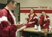 Scott Anderson (left), Brandon Lancaster (center) and Kevin Downham share a laugh before getting their ankles taped at Twin Lakes High School.